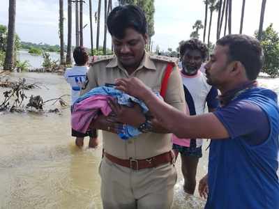 Woman from island village delivers midway; people, police carry mother and baby through flood waters