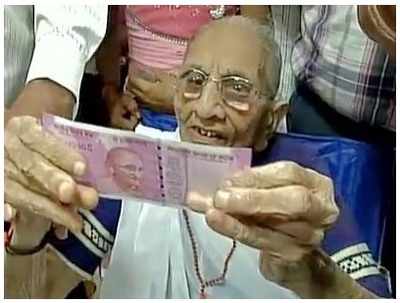 Prime Minister Narendra Modi's mother exchanges old notes in Gandhinagar