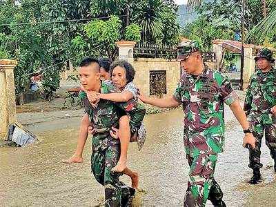 Mass burial in Indonesia as flood death toll tops 100