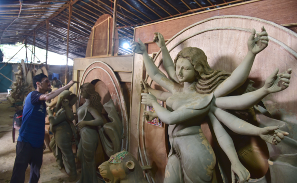 An artist from Bengaluru works on clay idols of Goddess Durga ahead of the puja.  Credit: Ratheesh Sundaram