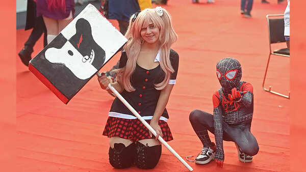 Cosplayer and a Spiderman fan pose for the camera