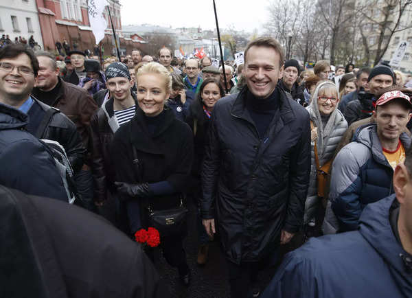 Russian opposition leader Alexei Navalny and his wife Yulia walk during an opposition rally in Moscow
