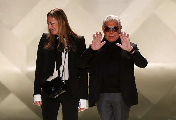 FILE PHOTO: Italian designer Cavalli and his wife Eva acknowledge applause on the catwalk at the end of his Roberto Cavalli Autumn/Winter 2013 collection at Milan Fashion Week