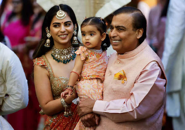 Mukesh Ambani poses for a picture with his daughter Isha Ambani and granddaughter Aadiya during the pre-wedding ceremony of Anant Ambani and Radhika Merchant, at his residence in Mumbai