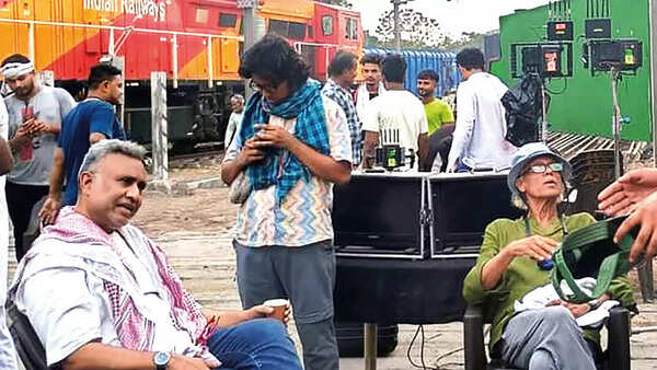 Anubhav Sinha and Sudhir Mishra discussing shots at the Railway yard in Kanpur