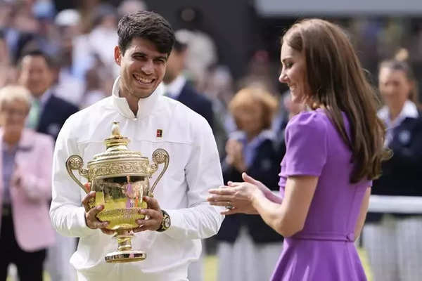 Carlos Alcaraz of Spain reacts after receiving his trophy from Kate, Princess of Wales