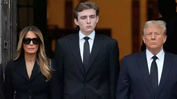 Barron Trump with his stepmother Melania and Donald Trump