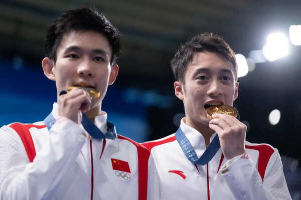 China's Lian Junjie and Yang Hao celebrate with their medals following the men's synchronised 10m platform diving at the Paris 2024 Olympic Games at the Aquatics Centre in Saint-Denis, north of Paris, on July 29, 2024.