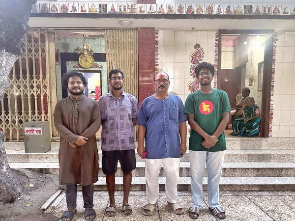 Goswami (in blue) with students Muztahid Abrar Siddique, Robin Mojumdar and Abrar Faiyaz, guard the temple on Friday night.