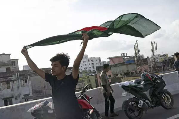 A boy celebrates with a national flag after the resignation of prime minister Sheikh Hasina in Dhaka, Bangladesh, Aug 6, 2024.