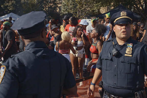 Police move revelers from the street after a shooting on Eastern Parkway, near the corner of Franklin Avenue. (AP)
