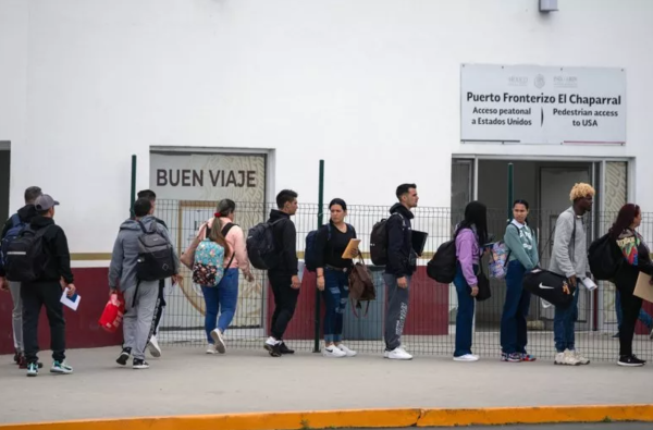 Asylum seekers queue at the El Chaparral crossing port to attend their appointment with US authorities at the US-Mexico border in Tijuana, Baja California State, Mexico, on June 5, 2024. (AFP)