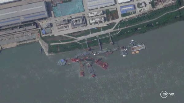 A series of satellite images from Planet Labs from June appear to show cranes at the Wuchang shipyard.