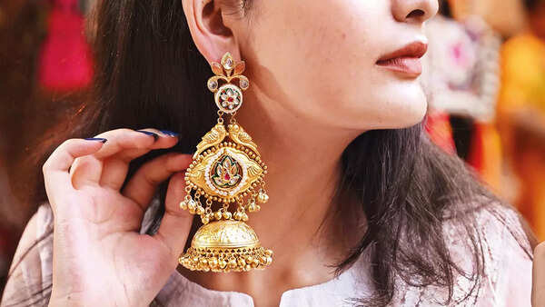 Copper earrings, with golden coating have intricate meenakari work, perfect for the festive season