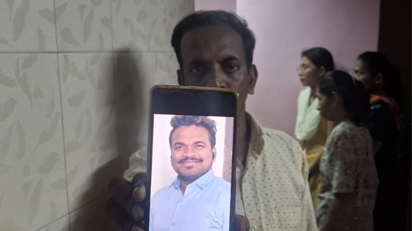 Victim Akash Maeen's father , Dattatreya, holds his photo
