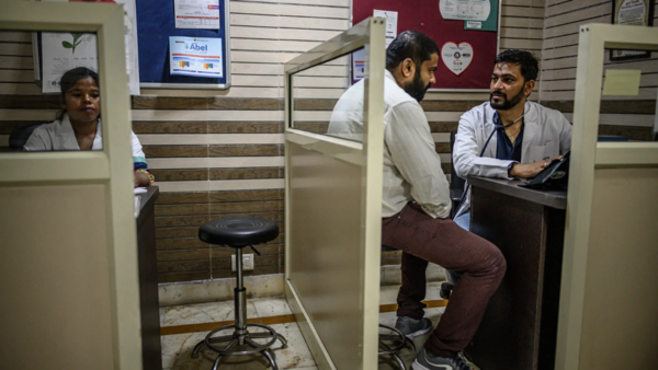 Dr Bhadoriya with a patient during free clinic hours, which he runs once a month at his private clinic in Delhi.