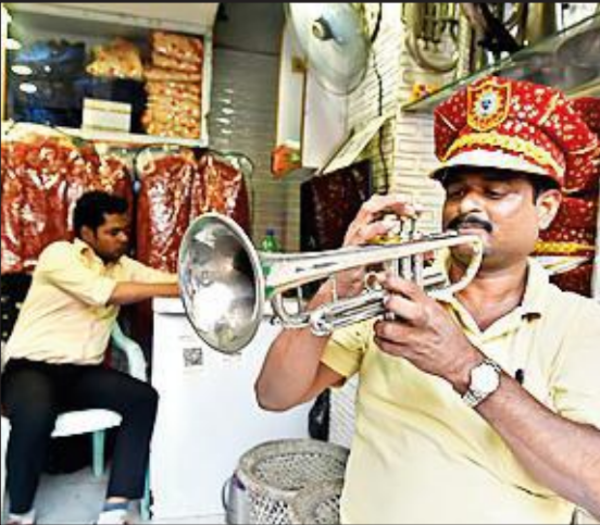Band members tune instruments ahead of the wedding season