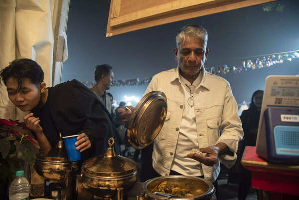 Adil Hussain trying momos at a stall in NEF food zone
