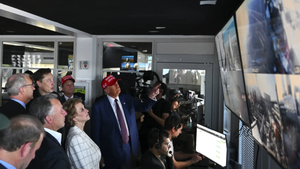 Donald Trump listens as Elon Musk explains the operations (Pic credit: AP)