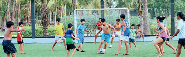 An athlete training and children playing at Sol