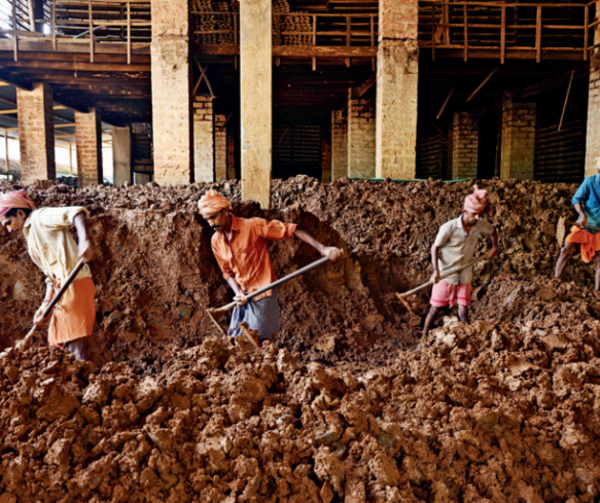 Workers process clay