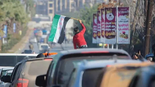 A boy holds the Syrian opposition flag in Aleppo, Syria.