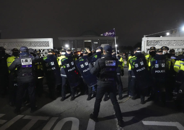 Police officers stand guard in front of the National Assembly in Seoul (Photo: AP)