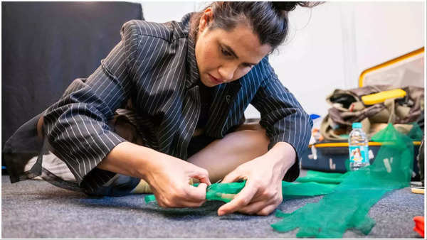 Nikhita Gandhi stitching her gloves right before the concert