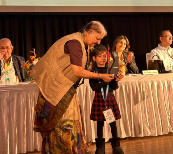 Vaanya receiving an award