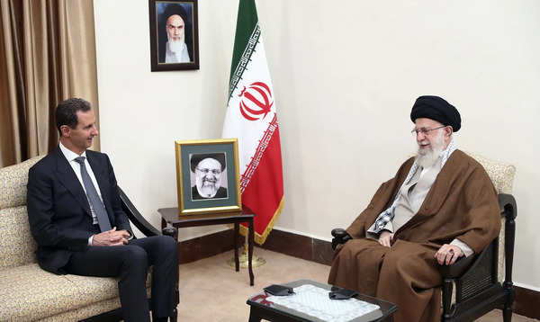 Supreme Leader Ayatollah Ali Khamenei, right, speaks with Syrian President Bashar Assad