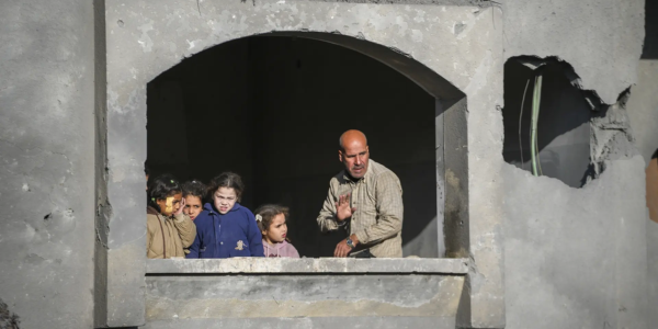 Neighbours watch the funeral procession of the victims of an Israeli strike on a home late Saturday, in Deir al-Balah, central Gaza Strip (Pic credit: AP)