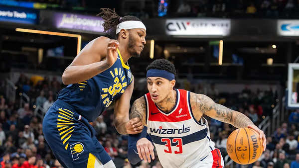 Wizards forward Kyle Kuzma (33) dribbles the ball while Indiana Pacers center Myles Turner (33) defends in the first half at Gainbridge Fieldhouse