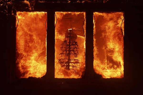 Wildfires burn out of control across Los Angeles area and kill 5 as thousands flee homes