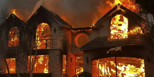 The Palisades Fire burns a structure in the Pacific Palisades neighborhood of Los Angeles (Pic credit: AP)