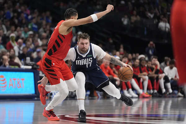 Mavs star Luka Doncic will be out about a month before check on calf injury, AP source says