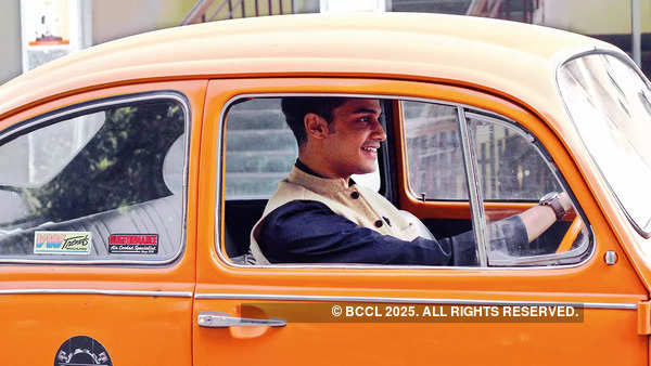 Yashwant Singh Chauhan in his Orange Volkswagen Beetle