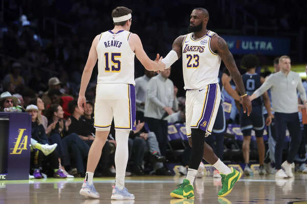 Los Angeles Lakers forward LeBron James (23) celebrates with guard Austin Reaves (15) during the first half of an NBA basketball game against the Memphis Grizzlies, Sunday, Dec. 15, 2024, in Los Angeles. (Image via AP Photo/Jessie Alcheh) Austin Reaves and LeBron James of the Lakers