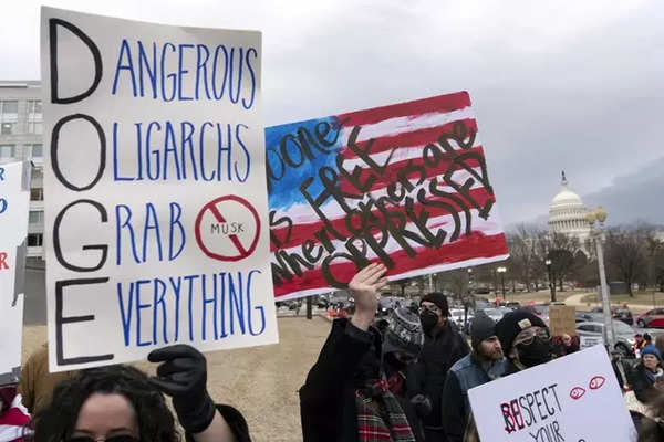 People protest during a rally against Elon Musk outside the US department of labor in Washington, Wednesday, February 5, 2025. (AP)