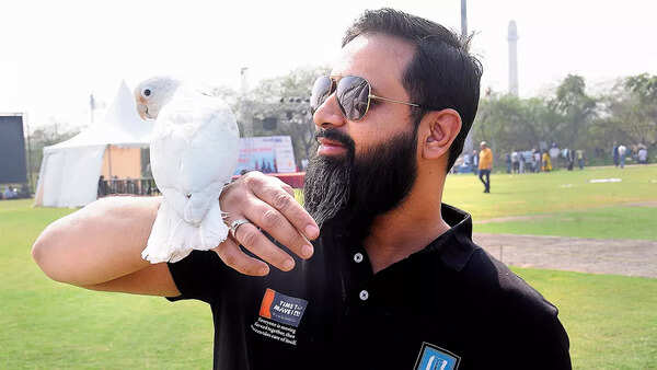 Mohd Dawar posing with Jimmy, a Goffin Cockatoo