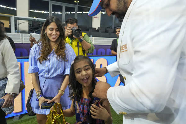 Dubai: Indian cricket team captain Rohit Sharma with his family after India won...