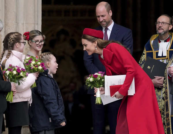 Britain's Kate, the Princess of Wales is presented with flowers after attending ...