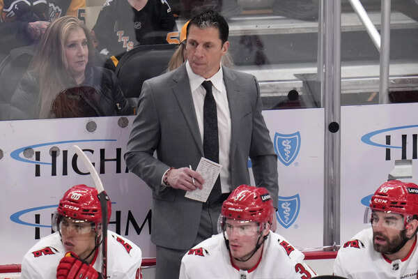 Carolina Hurricanes coach Rod Brind'Amour stands behind the bench during the first period of the team's NHL hockey game against the Pittsburgh Penguins in Pittsburgh, Tuesday, March 26, 2024.