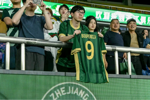A fan holds a Boupendza shirt at Wednesday’s Zhejiang v Meizhou Hakka match in Hangzhou. Photo: AFP