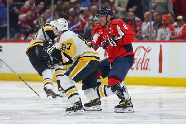 Alex Ovechkin #8 of the Washington Capitals battles for a puck against Sidney Crosby #87 of the Pittsburgh Penguins