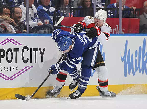 Brady Tkachuk #7 of the Ottawa Senators hits Scott Laughton #24 of the Toronto Maple Leafs in the second period of Game