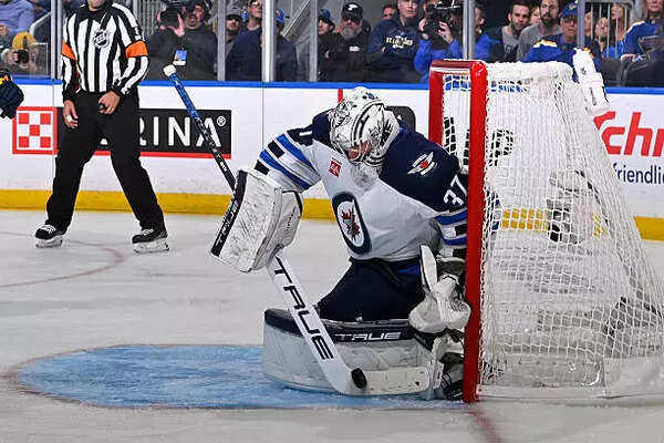 Connor Hellebuyck of the Winnipeg Jets defends the net