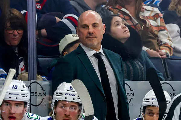 Head coach Rick Tocchet of the Vancouver Canucks looks on from the bench