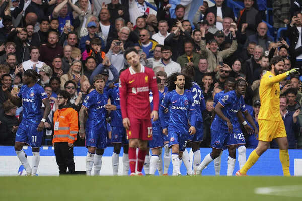 Chelsea players celebrate after forcing an own goal by Liverpool's Jarell Quansah during the English Premier League soccer match between Chelsea and Liverpool at Stamford Bridge stadium in London. (AP/PTI) Chelsea players celebrate after forcing an own goal by Liverpool's Jarell Quansa...