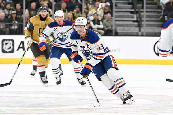 Vegas Golden Knights battles for the puck with the Edmonton Oilers