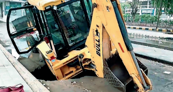 A digger fell into a crater near Shastrinagar BRTS Crossroads early in the morning A digger fell into a crater near Shastrinagar BRTS Crossroads early in the morning